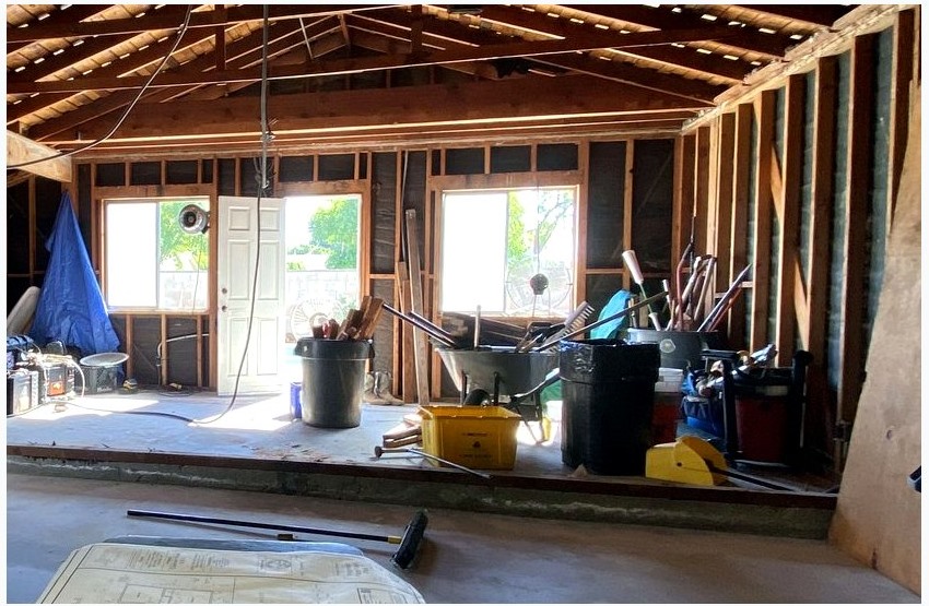 Construction plans on a jobsite table during a local ADU construction review