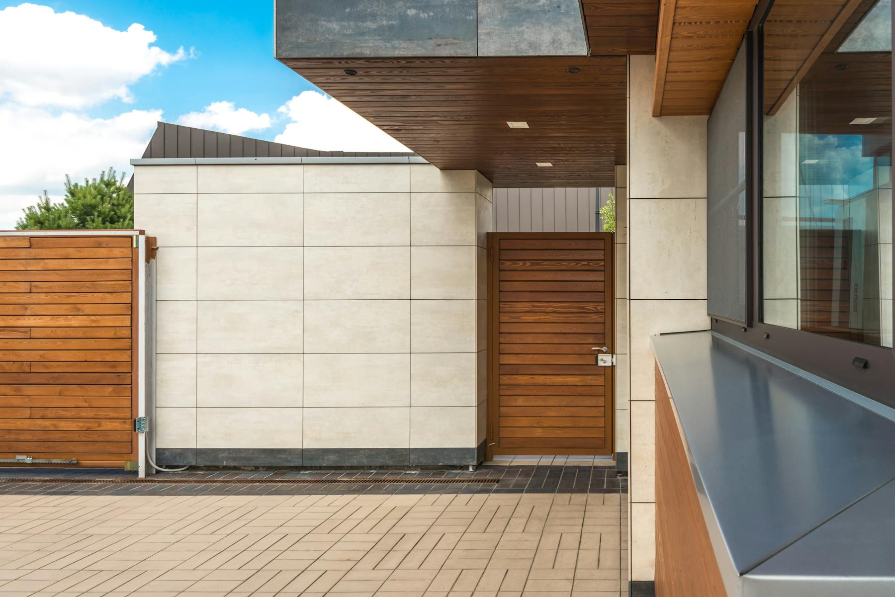 Modern compact backyard home exterior with wood privacy fencing